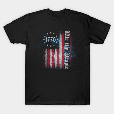 Black t-shirt featuring distressed American flag design with "1776" and "We the People" text, patriotic style.
