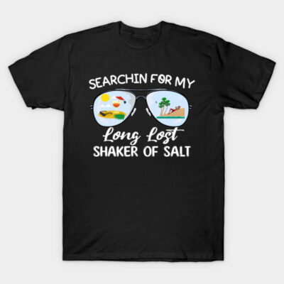 Black t-shirt with "Searchin for my long lost shaker of salt" text, featuring tropical sunglasses graphic design.