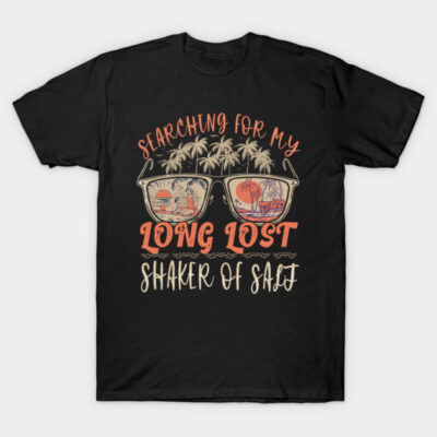 Black t-shirt with "Searching for My Long Lost Shaker of Salt" text, palm tree and sunglasses graphic, casual beachwear.