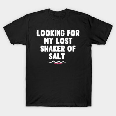 Black t-shirt with "Looking for my lost shaker of salt" text in white, casual style, cotton material.