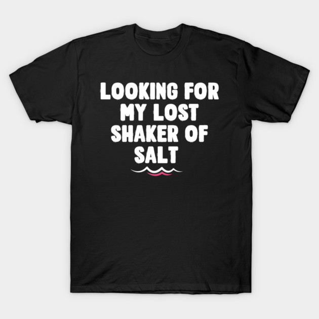 Black t-shirt with "Looking for my lost shaker of salt" text in white, casual style, cotton material.