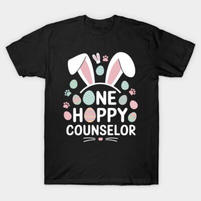 Black t-shirt with "One Happy Counselor" text and pastel Easter design featuring bunny ears and eggs.