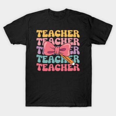 Black t-shirt with colorful "Teacher" text, bow, and pencil design. Ideal for educators. Comfortable cotton material.