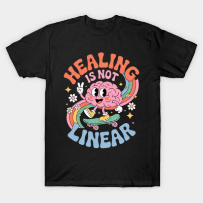 Black t-shirt with colorful "Healing Is Not Linear" design featuring a cartoon brain on a skateboard, casual wear.
