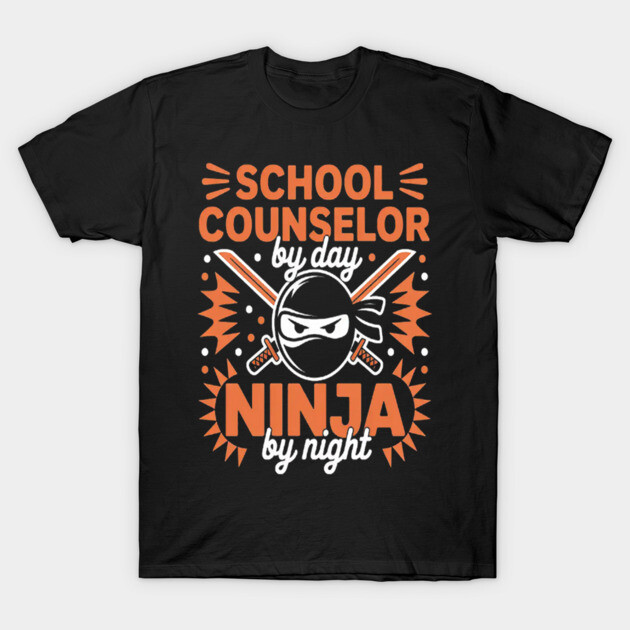 Black t-shirt with "School Counselor by Day, Ninja by Night" graphic in orange and white, casual cotton style.