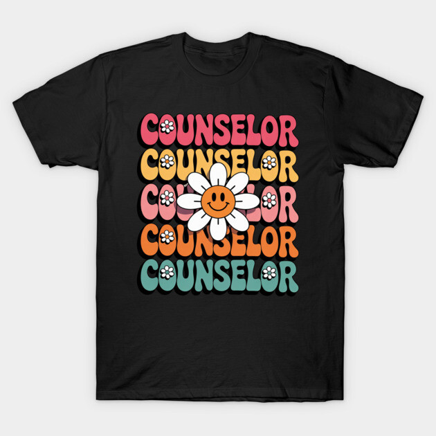 Black t-shirt with colorful retro "Counselor" text and smiley daisy graphic, casual style, cotton material.