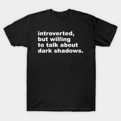 Black cotton t-shirt with white text "introverted, but willing to talk about dark shadows," casual style, unisex.