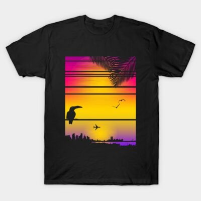 Black t-shirt with vibrant cityscape and sunset design, featuring toucans and palm trees. Perfect for casual wear.