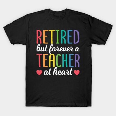 Black t-shirt with rainbow text "Retired but forever a teacher at heart" for retired educators, casual wear.