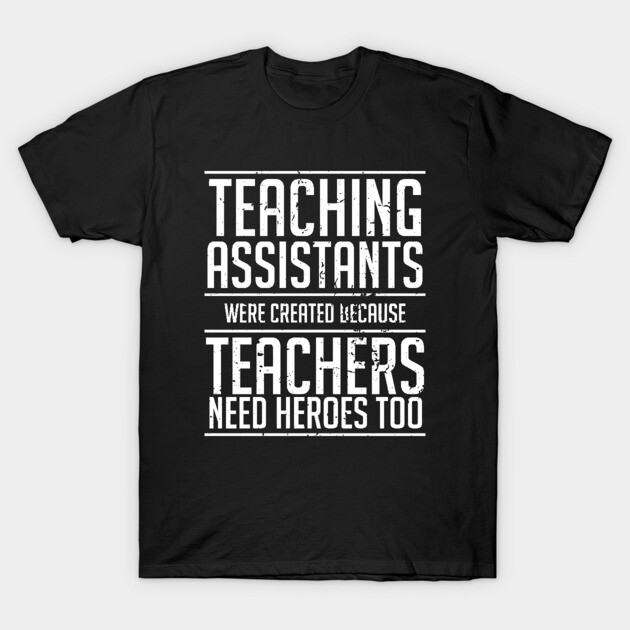 Black T-shirt with white text reading "Teaching Assistants were created because teachers need heroes too," casual style.