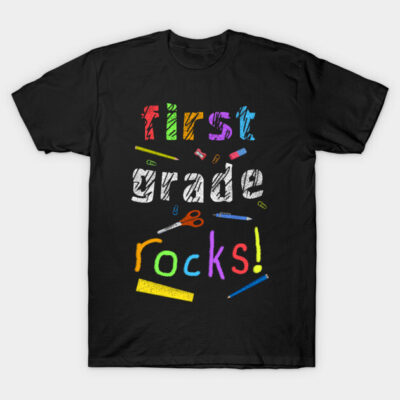 Black "First Grade Rocks" T-shirt with colorful lettering, casual style, perfect for school events or casual wear.