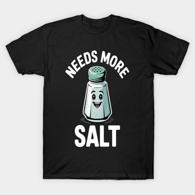 Black t-shirt with humorous "Needs More Salt" graphic featuring a smiling salt shaker, casual wear, cotton fabric.