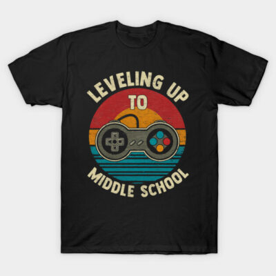 Black t-shirt with retro game controller design and "Leveling Up to Middle School" text, perfect for gaming enthusiasts.