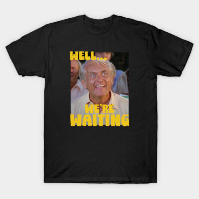 Black t-shirt with humorous "Well... We're Waiting" graphic, featuring bold yellow text, casual wear, cotton material.
