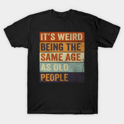 Black t-shirt with colorful vintage text design, "It's Weird Being the Same Age As Old People," casual wear.