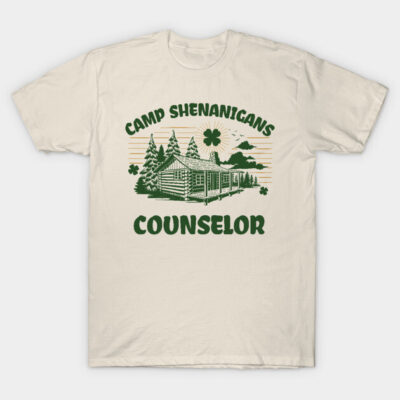 Beige "Camp Shenanigans Counselor" graphic t-shirt with green log cabin design, ideal for casual wear.