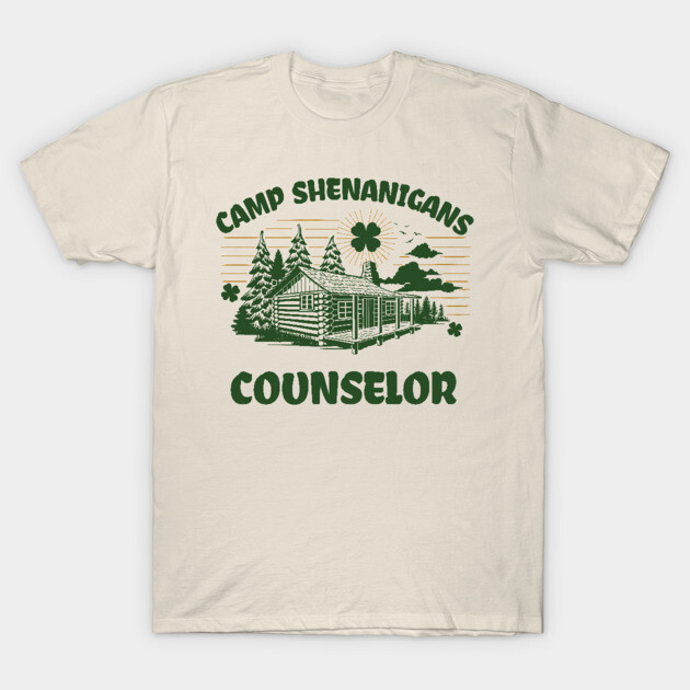 Beige "Camp Shenanigans Counselor" graphic t-shirt with green log cabin design, ideal for casual wear.