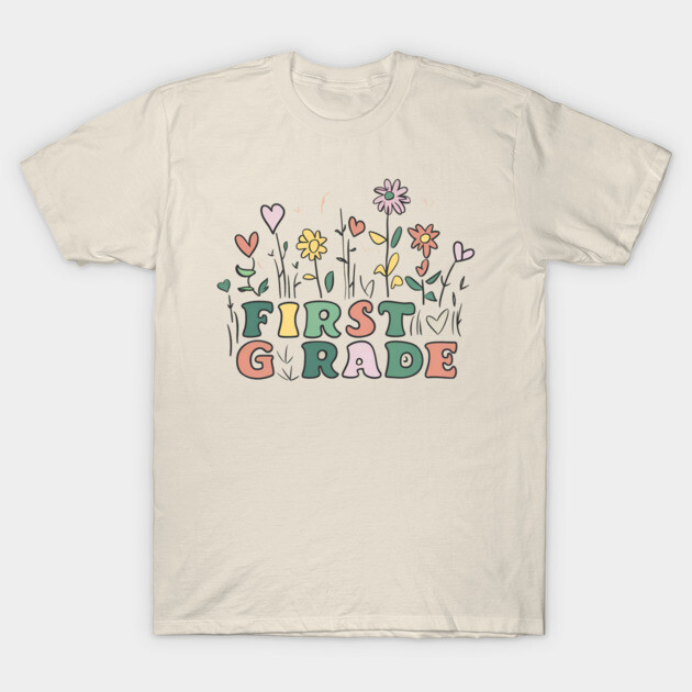 Cream t-shirt with colorful "First Grade" floral design, casual style, ideal for school or casual wear.