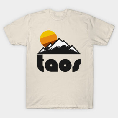 Beige t-shirt with mountain sunset graphic and "Taos" text, casual cotton style for outdoor enthusiasts.