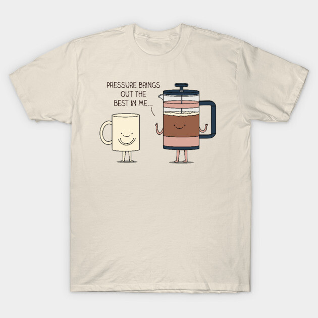 Beige T-shirt with cute coffee mug and French press graphic, text "Pressure brings out the best in me." Casual wear.