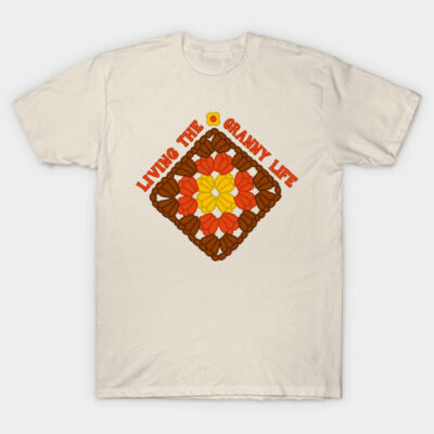 Cream t-shirt with colorful crochet pattern design and "Living the Granny Life" text, casual style, cotton fabric.