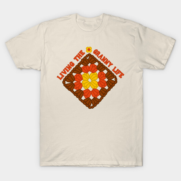 Cream t-shirt with colorful crochet pattern design and "Living the Granny Life" text, casual style, cotton fabric.