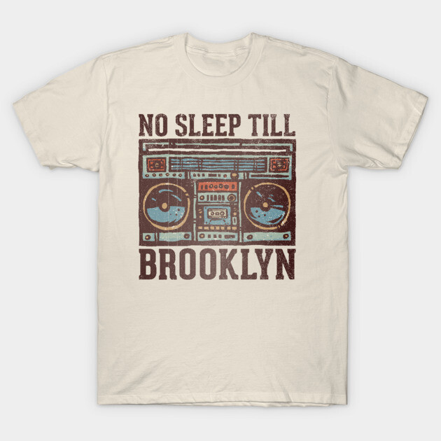 Beige T-shirt with vintage boombox graphic and "No Sleep Till Brooklyn" text, casual wear, cotton fabric.