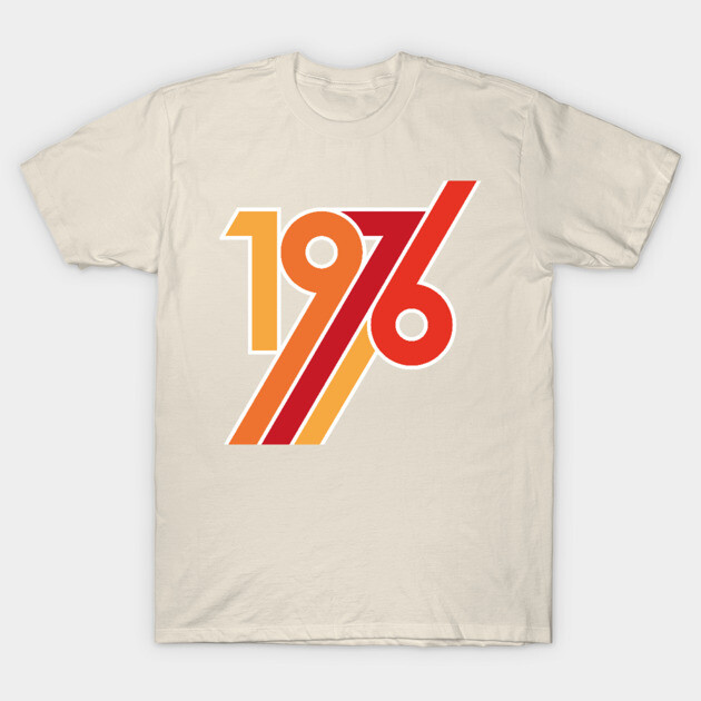 Beige t-shirt with retro "1976" graphic print in red and orange, cotton material, casual vintage style.