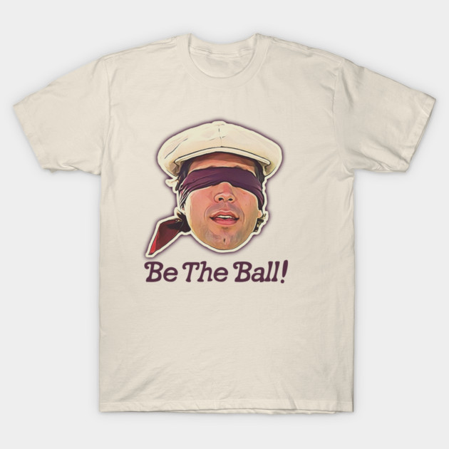 Cream t-shirt with "Be The Ball!" graphic, featuring a blindfolded character illustration. Casual wear, soft cotton material.