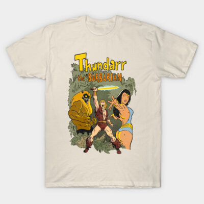 Beige graphic T-shirt featuring vintage comic design, showcasing vibrant characters and text "Thundarr the Barbarian".