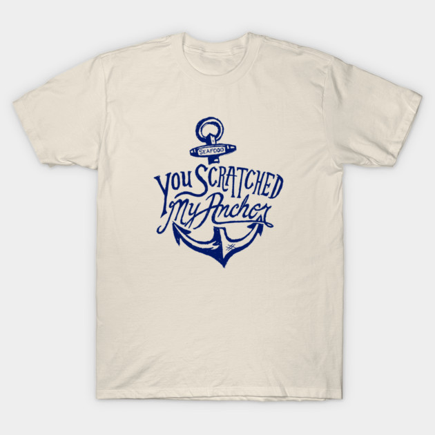Beige t-shirt with navy blue nautical anchor design and text, casual style, ideal for everyday wear.