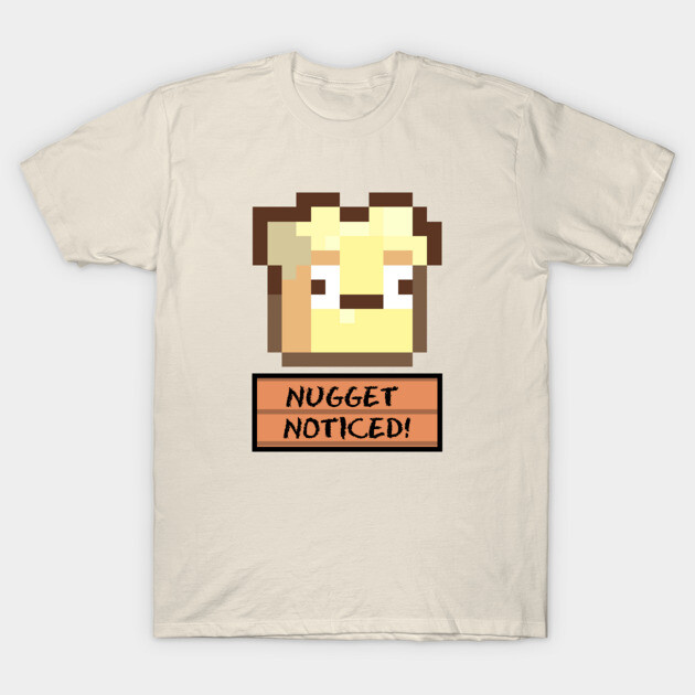 Beige t-shirt with pixel art design and "Nugget Noticed" text, casual wear for gaming enthusiasts.