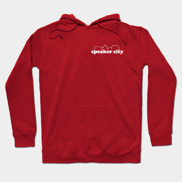 Red hoodie with "Speaker City" logo, front pocket, and drawstring hood, perfect for casual wear and comfort.