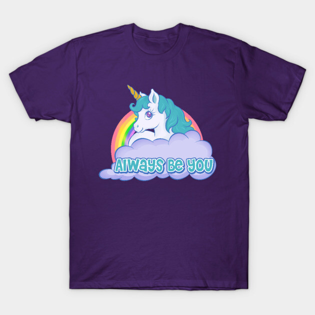 Purple t-shirt with unicorn design, rainbow background, and "Always Be You" text. Casual wear, cotton material.