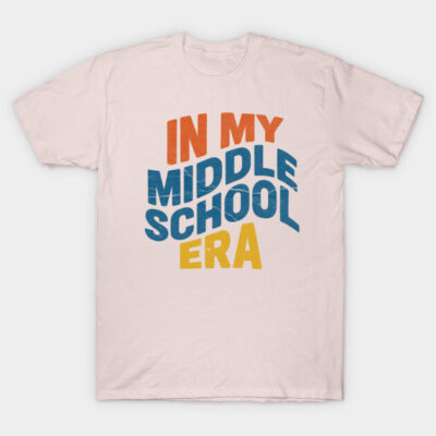 "Light pink t-shirt with 'In My Middle School Era' text in red, blue, yellow. Casual style, cotton material."