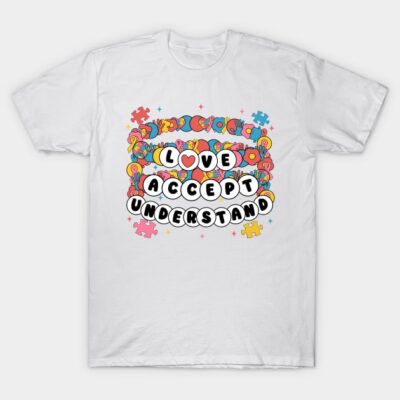 White t-shirt with colorful puzzle design and "Love Accept Understand" text, made of soft cotton, casual wear.