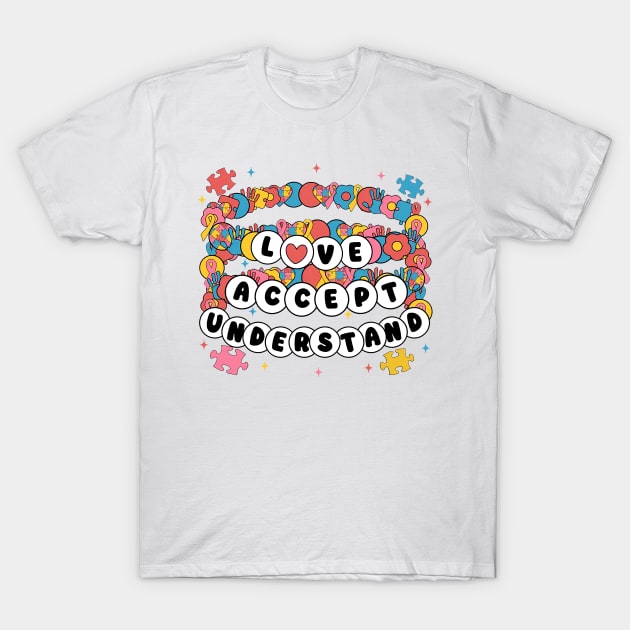 White t-shirt with colorful puzzle design and "Love Accept Understand" text, made of soft cotton, casual wear.
