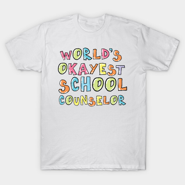 White T-shirt with colorful "World's Okayest School Counselor" text, casual style, perfect for school settings.