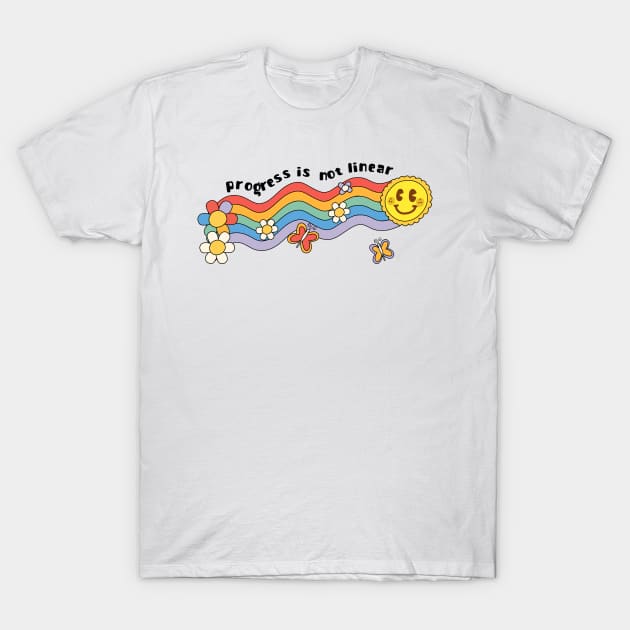 White t-shirt with colorful "Progress is Not Linear" graphic, featuring rainbow, sun, and flowers. Cotton, casual wear.