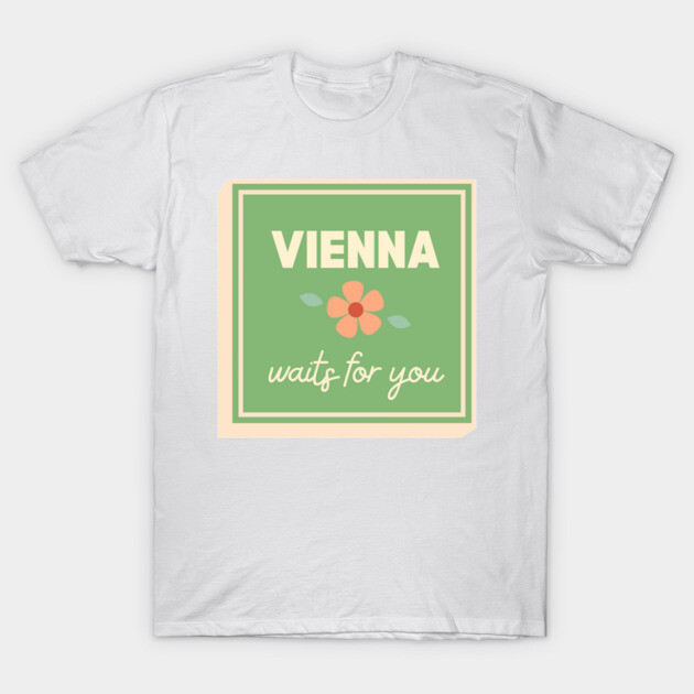 White T-shirt with "Vienna waits for you" graphic, green and peach floral design. Casual, comfortable cotton wear.