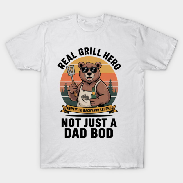 White t-shirt with "Real Grill Hero" bear graphic, BBQ-themed novelty gift, perfect for outdoor cooking enthusiasts.