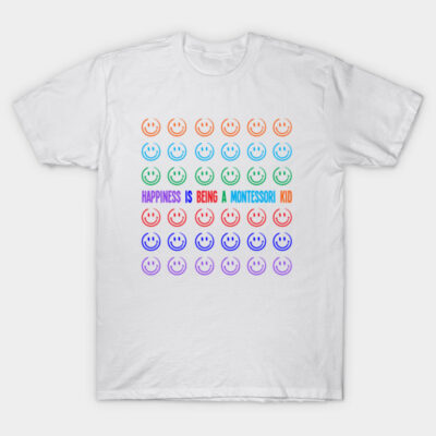 White T-shirt with colorful smiley faces and text "Happiness is Being a Montessori Kid," casual and fun design.