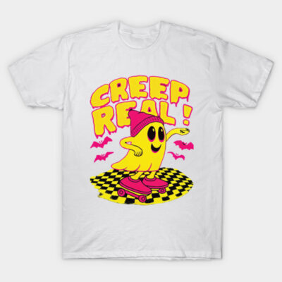White t-shirt with "Creep Real" text, featuring a yellow ghost on a skateboard, wearing a pink beanie, casual style.