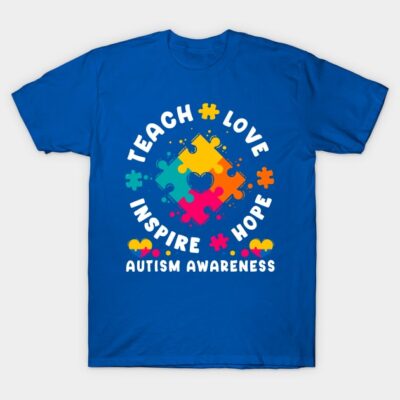 Blue autism awareness t-shirt with colorful puzzle design, "Teach Love Inspire Hope" text, cotton material, unisex fit.