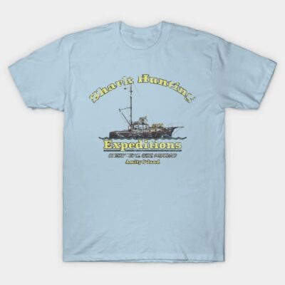 Light blue t-shirt featuring "Shark Hunting Expeditions" graphic design, casual wear, cotton material.