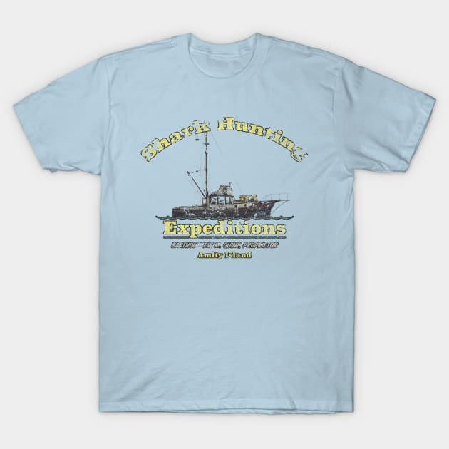 Light blue t-shirt featuring "Shark Hunting Expeditions" graphic design, casual wear, cotton material.