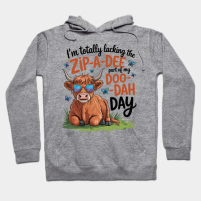 Gray hoodie with playful cow graphic and humorous text, casual style, ideal for everyday wear.