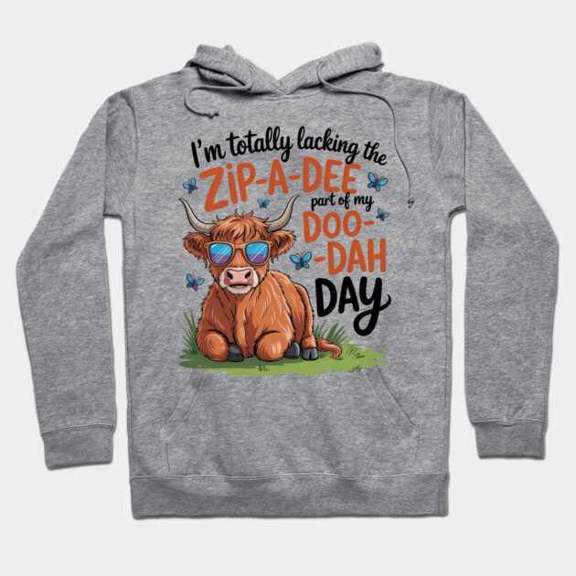 Gray hoodie with playful cow graphic and humorous text, casual style, ideal for everyday wear.