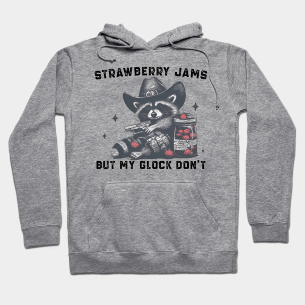 Gray hoodie with raccoon graphic, text "Strawberry Jams But My Glock Don't," casual style, soft cotton blend.