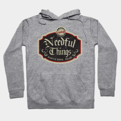 Gray hoodie with "Needful Things" vintage design, featuring front pocket and drawstrings, ideal for casual wear.